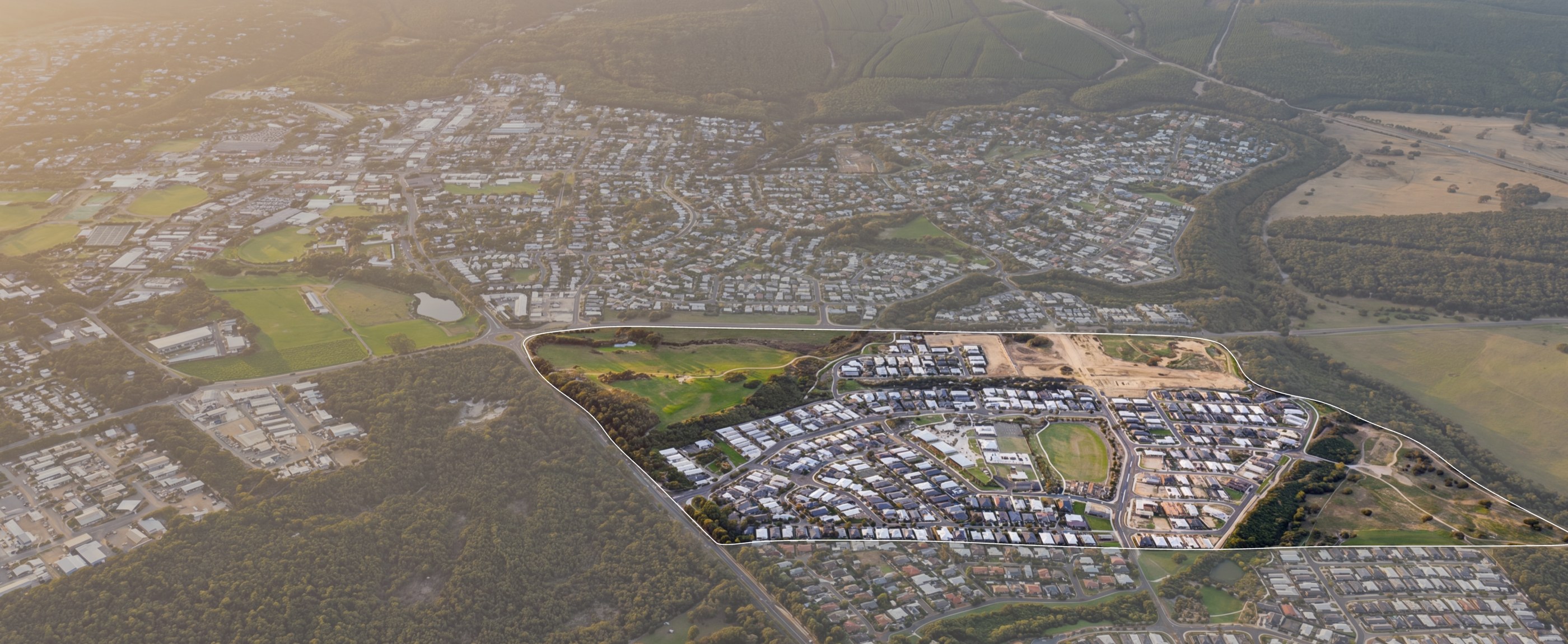 Aerial view of Rapids Landing with the estate boundary outlined, showing the primary school, a future high school, recreation centre, shopping precinct and future stages.