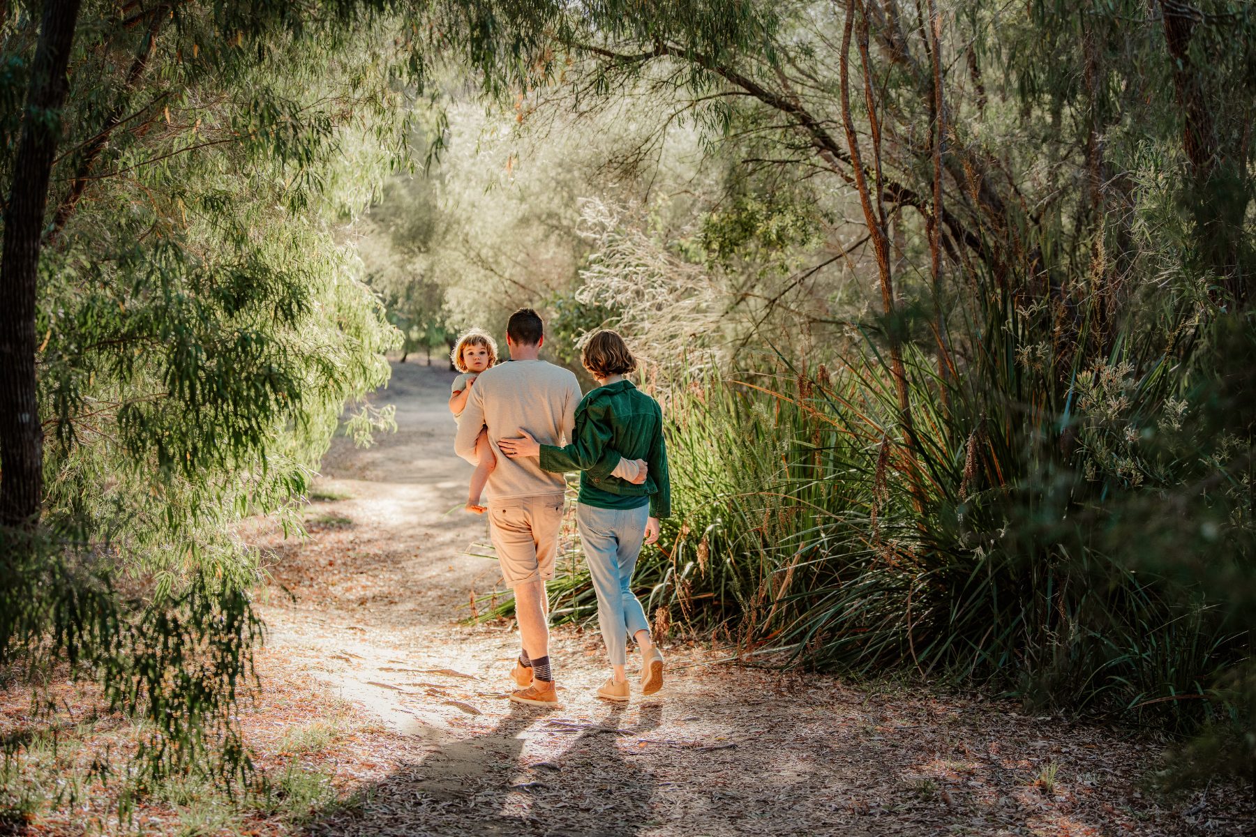 A family walking a bushland path at Rapids Landing